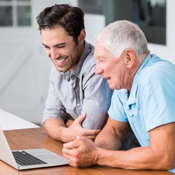 21714730_smiling-father-and-son-using-laptop - cropped-sm